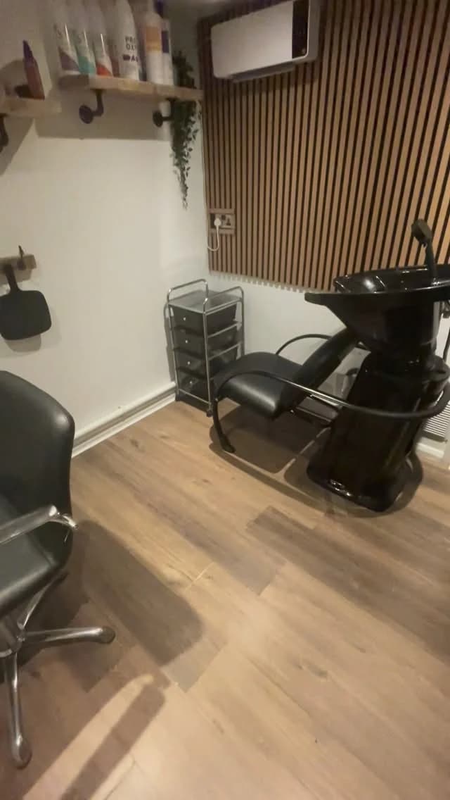 Amy's home studio: one styling chair, a backwash basin and a slatted wood wall