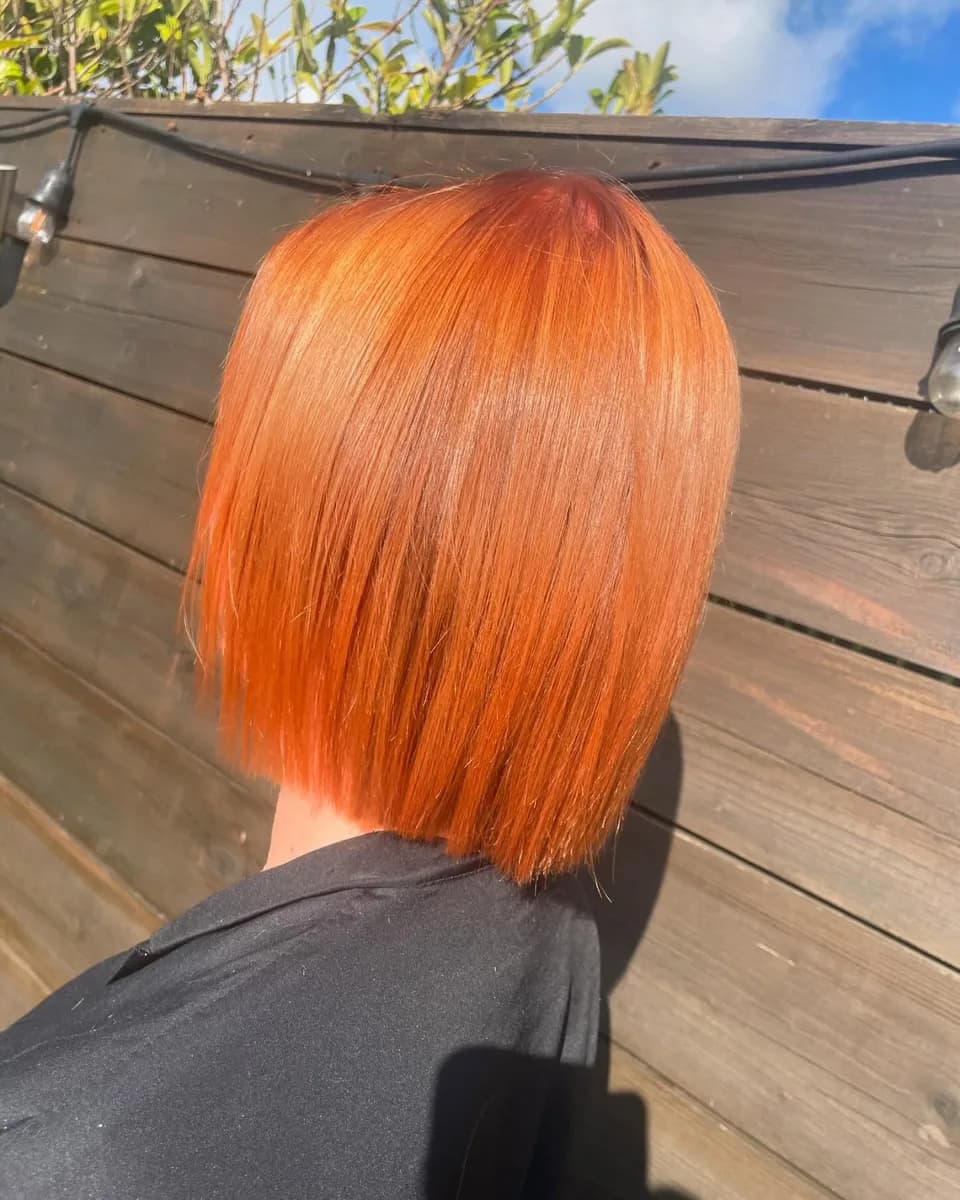 A bright copper bob, cut to one length and glossed